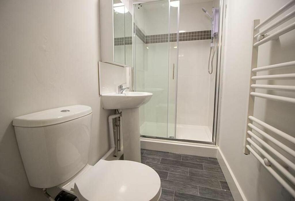 A modern bathroom featuring a sleek shower, con...