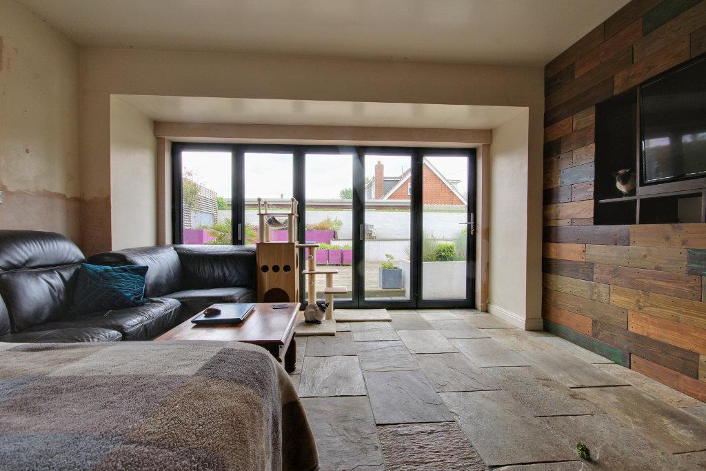 Sitting room with folding doors leading out in to 