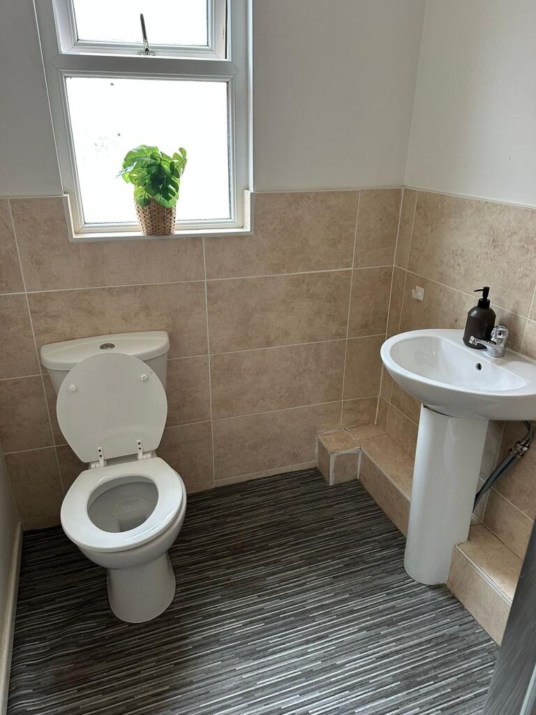 Bright and clean bathroom featuring a toilet an...