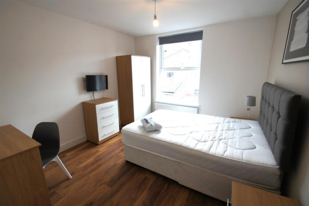Bright and spacious double bedroom featuring a ...