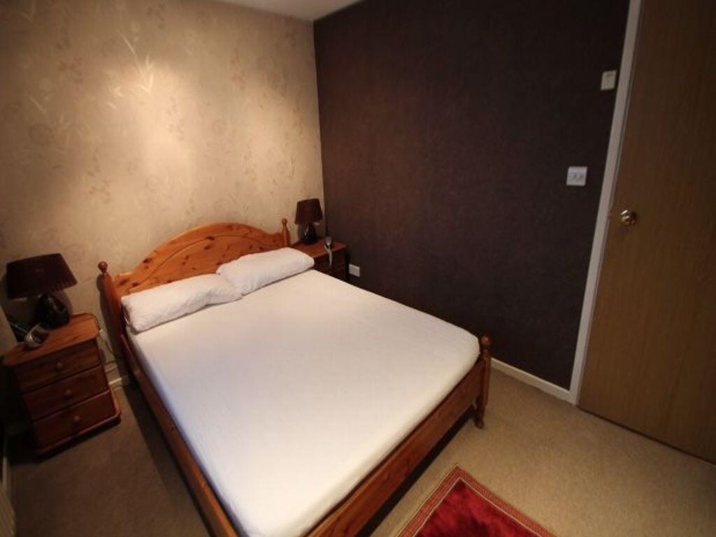 Neat double bedroom with a wooden double bed, c...