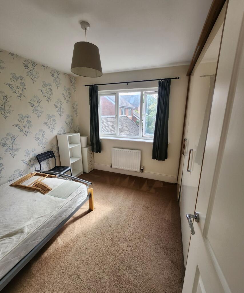 A neat and bright single bedroom featuring a la...