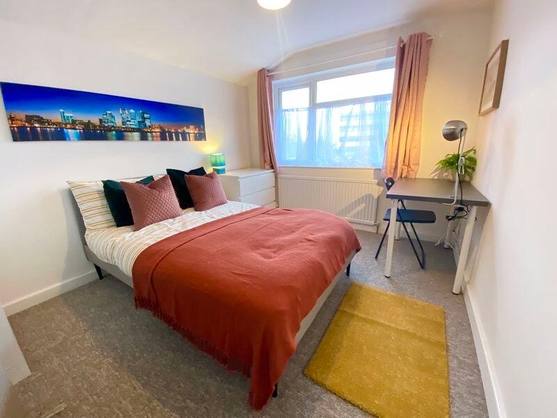 This inviting double bedroom features a cozy la...