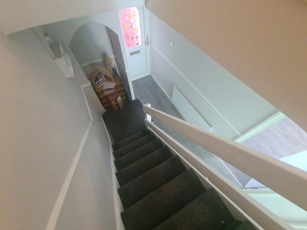 Bright and clean staircase with carpeted steps,...