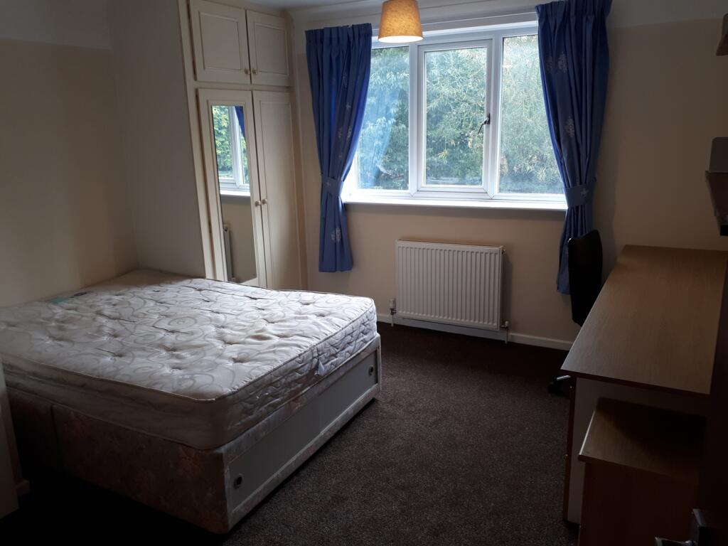 A bright and inviting double bedroom featuring ...