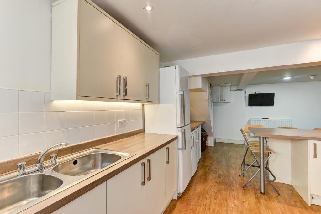 Bright and clean kitchen space featuring modern...