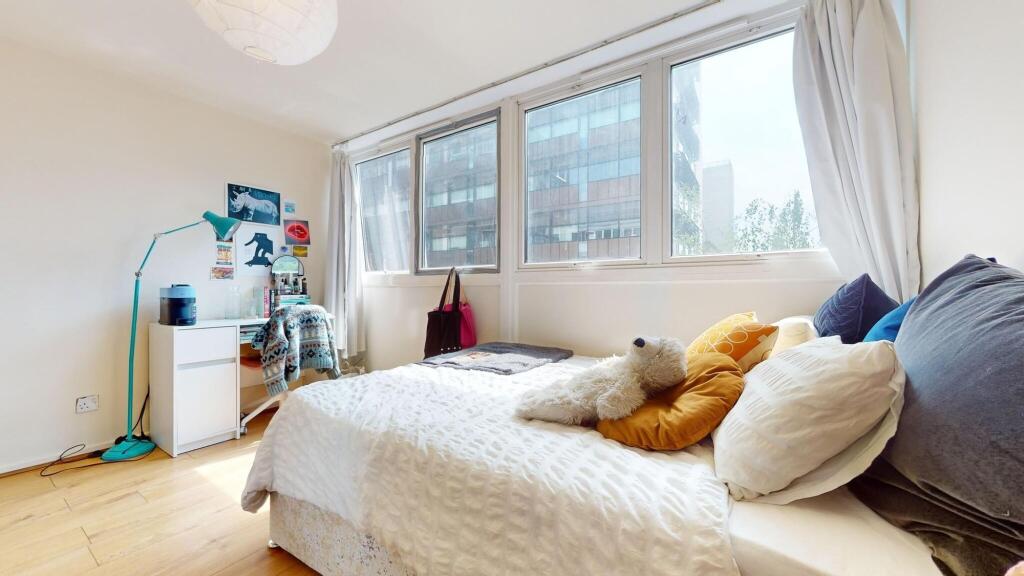 Bright and cozy single bedroom with a large win...