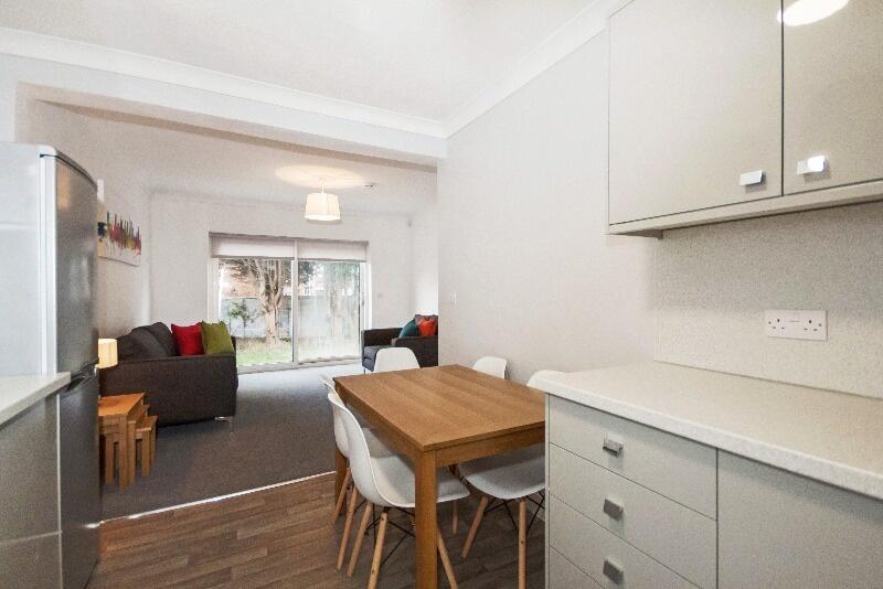 A bright and inviting living room with a modern...