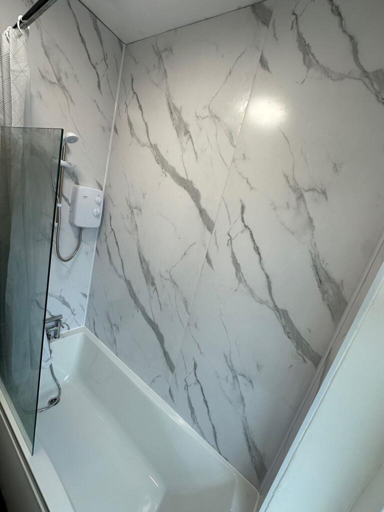 A sleek and modern bathroom suite featuring a c...