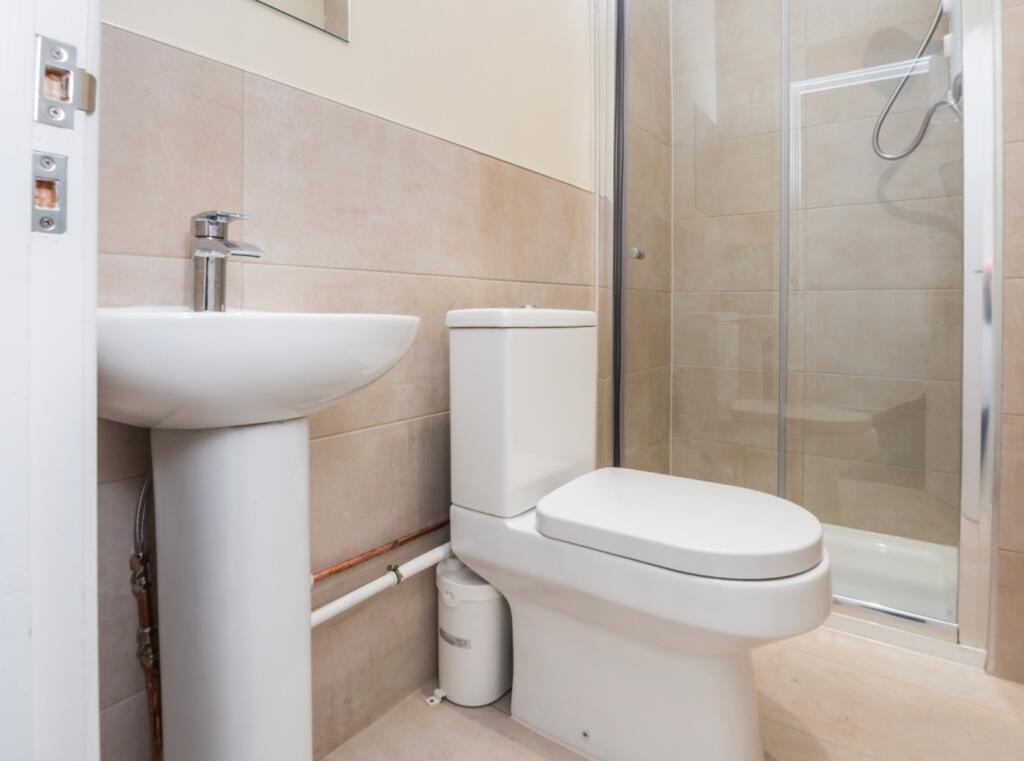 A modern and clean bathroom featuring a shower,...