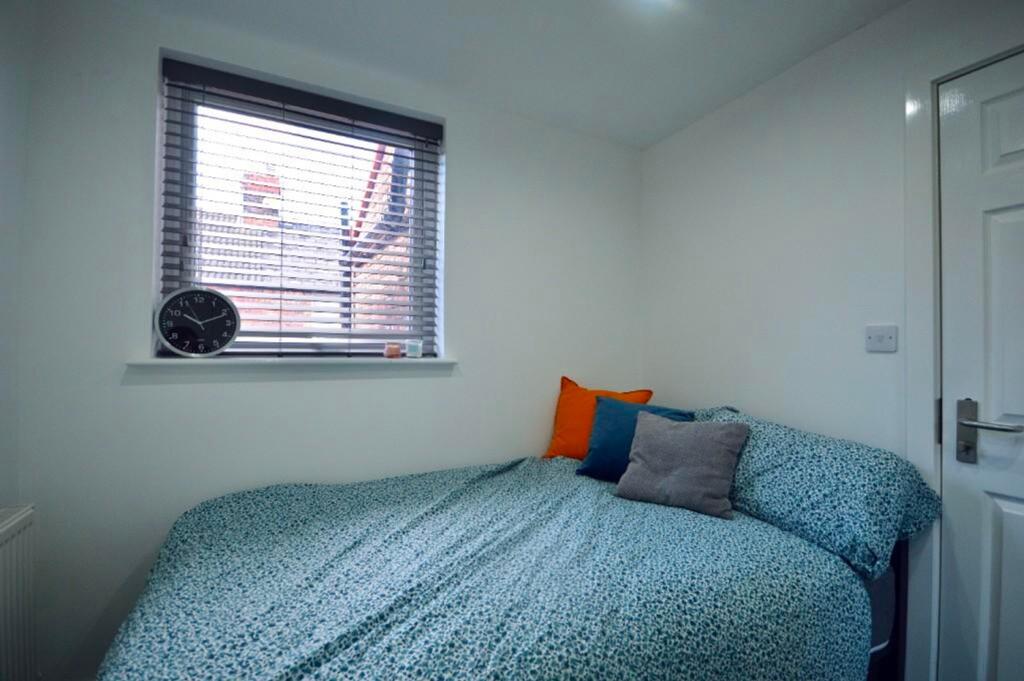 A cozy and inviting double bedroom with ample n...