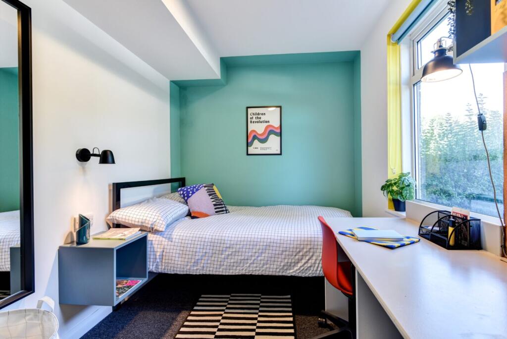 Bright and cozy bedroom featuring a double bed,...