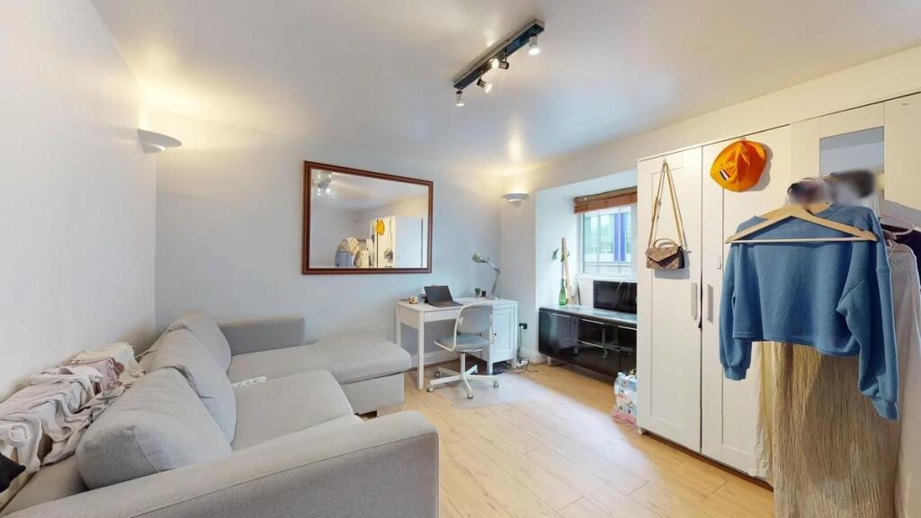 A bright and inviting living room featuring a c...