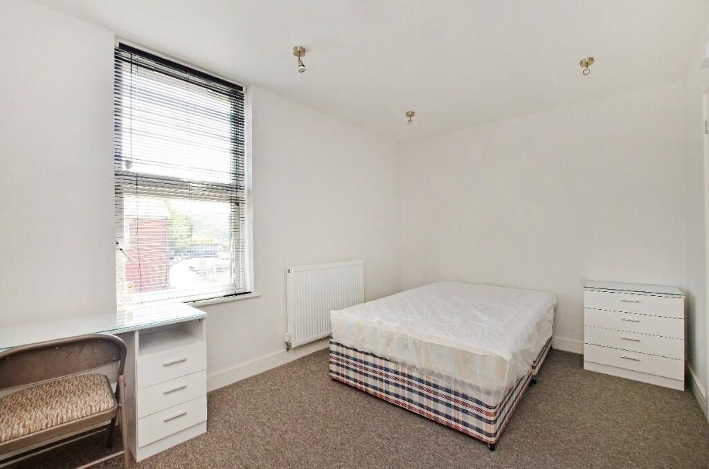 A bright and tidy double bedroom featuring a co...