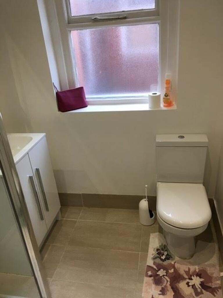 A modern bathroom featuring a sleek shower, con...