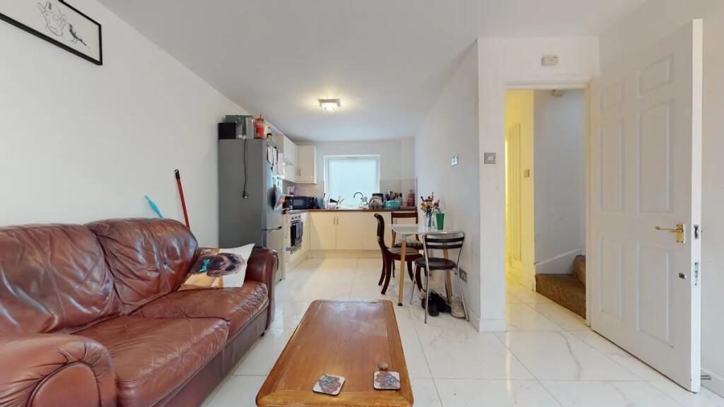 A bright and inviting living room with a leathe...