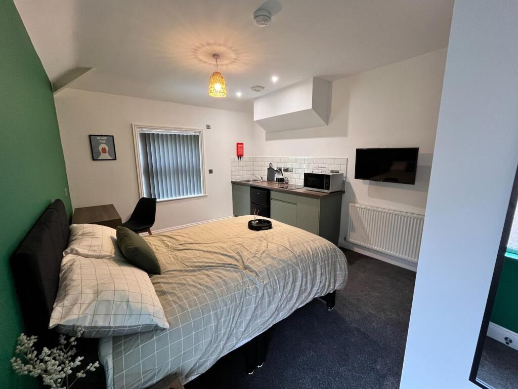 This charming double bedroom features a cozy am...