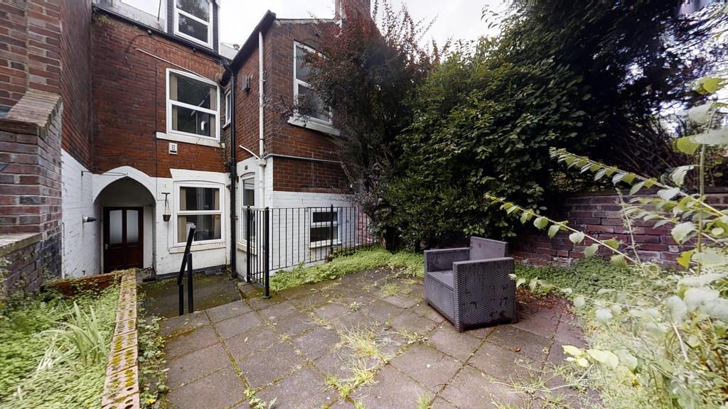 A private garden space featuring a paved patio ...