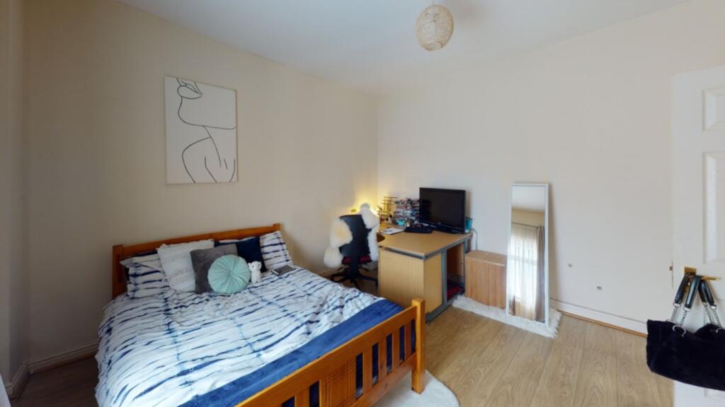 A bright and inviting double bedroom with ample...