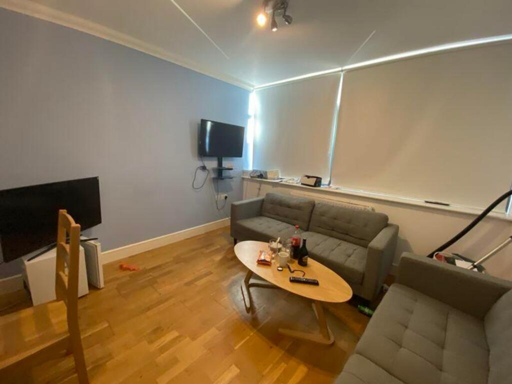 A spacious and inviting modern living room, per...