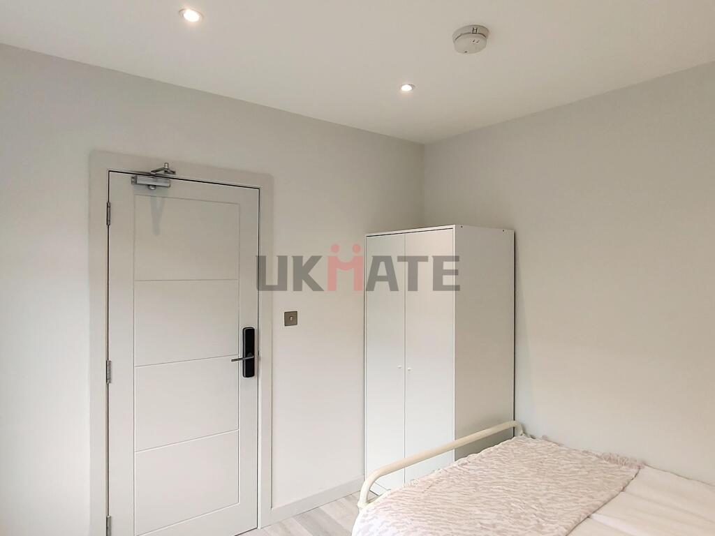 A bright and tidy bedroom featuring a white war...