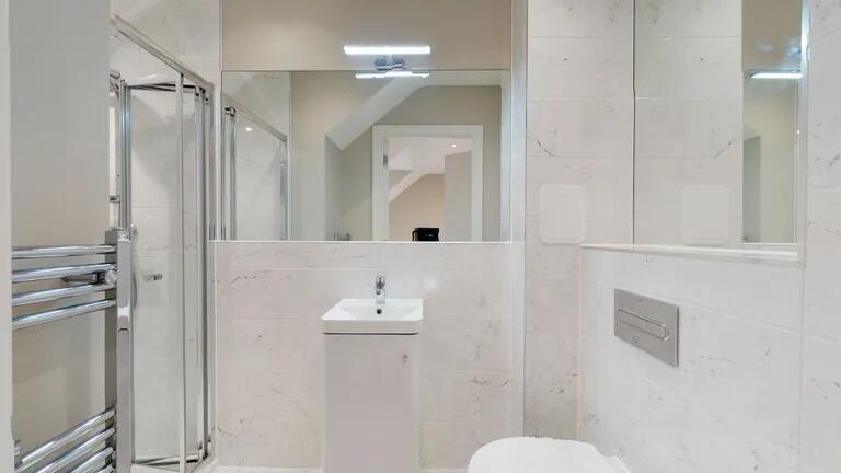 Bright and modern bathroom suite featuring slee...