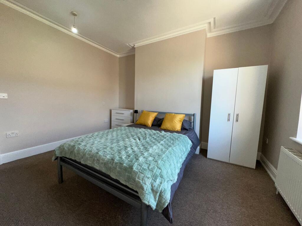 A neat and bright double bedroom featuring a co...