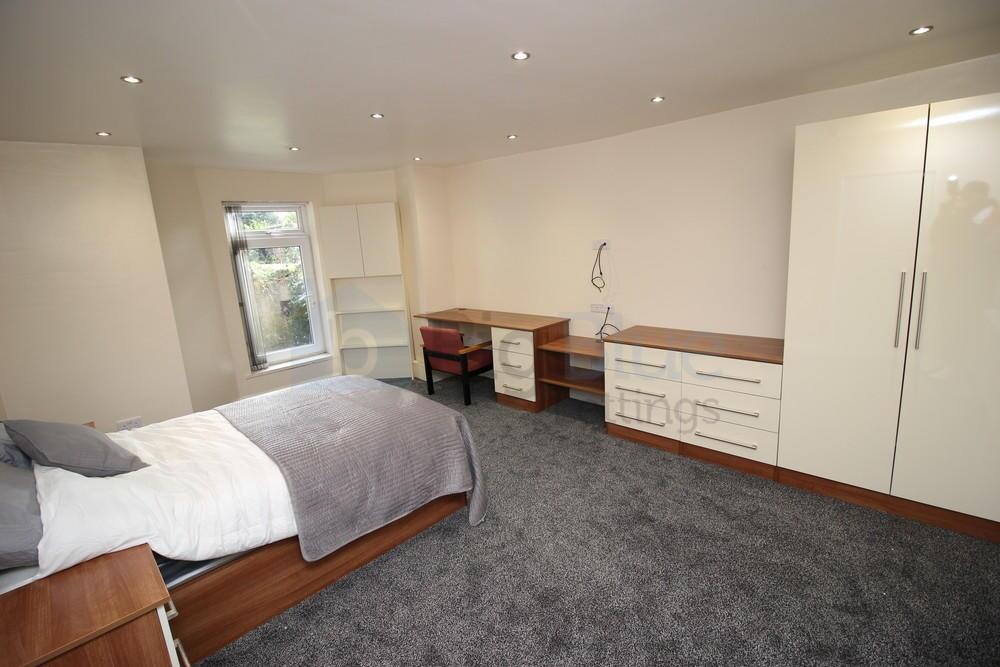 Bright and spacious double bedroom featuring a ...