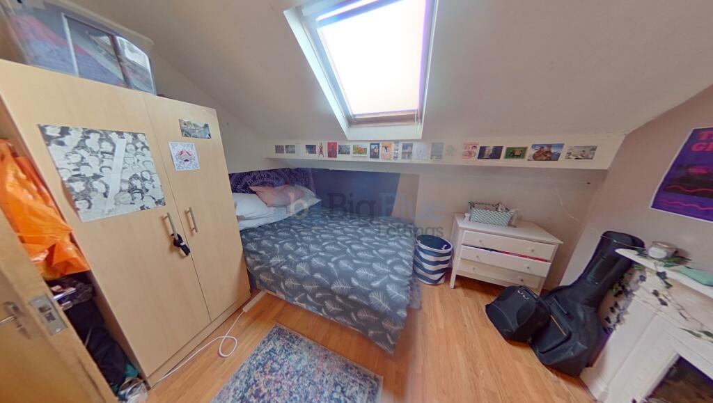 A cozy and well-lit master bedroom featuring a ...