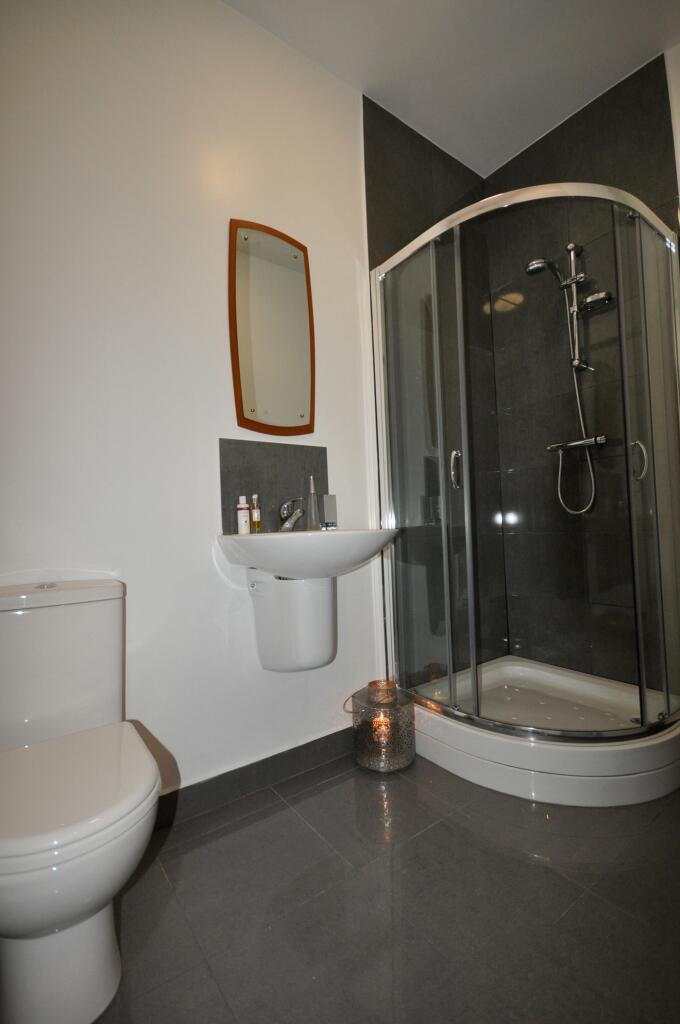 A modern and tidy bathroom featuring a sleek sh...