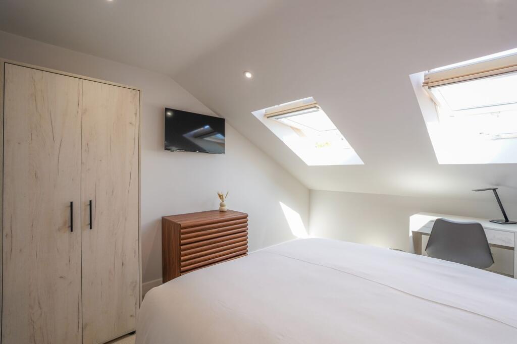 Bright and airy bedroom with modern furniture, ...