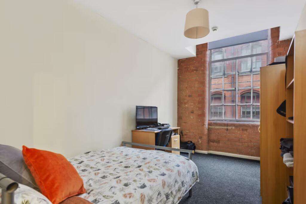 A bright and inviting double bedroom featuring ...