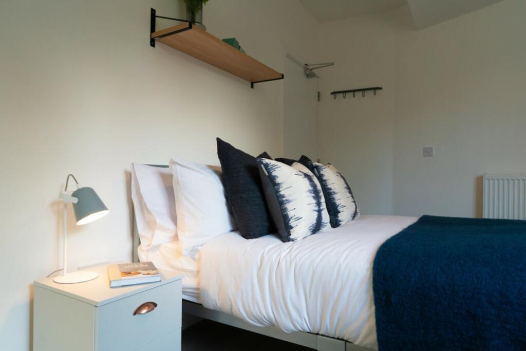 A bright and inviting double bedroom featuring ...