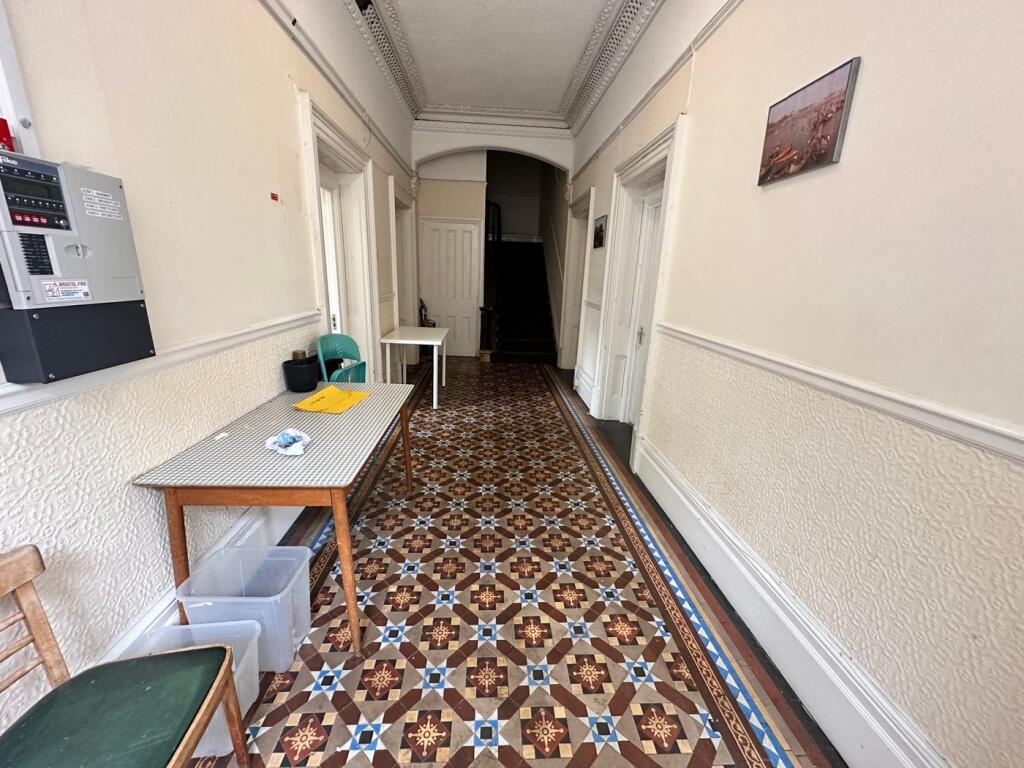 A spacious and well-maintained hallway with bea...