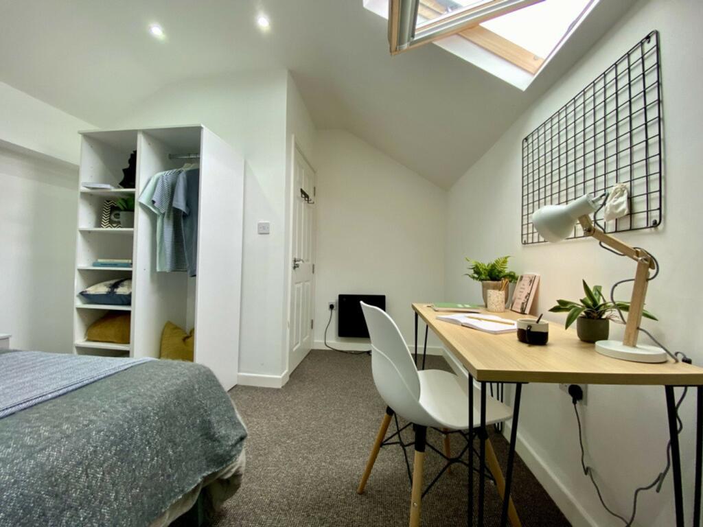 A bright and inviting double bedroom with moder...