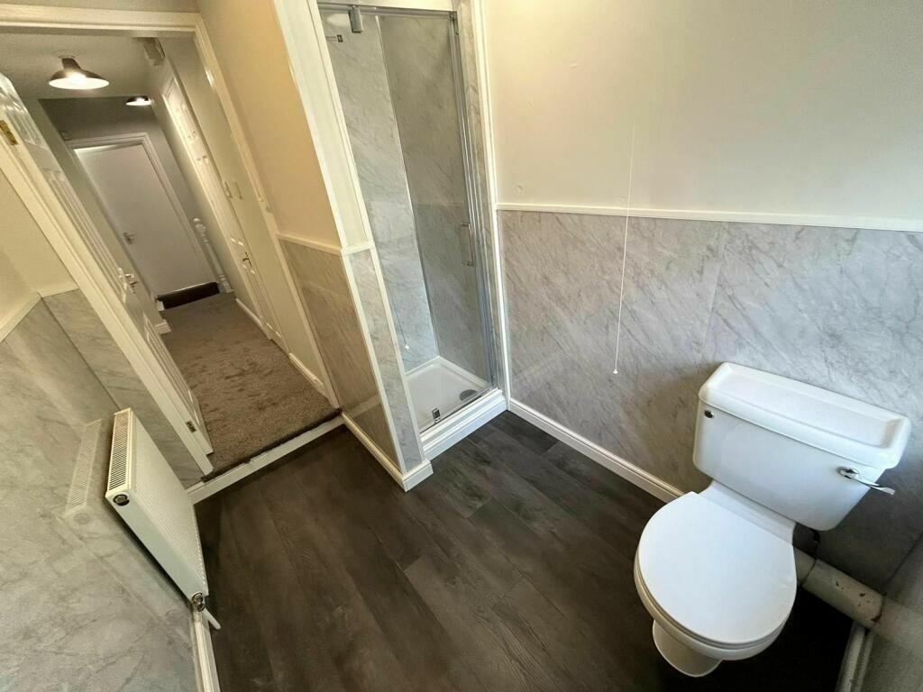Bright and tidy bathroom featuring a clean toil...