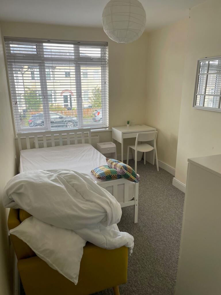 A bright and tidy single bedroom featuring a la...