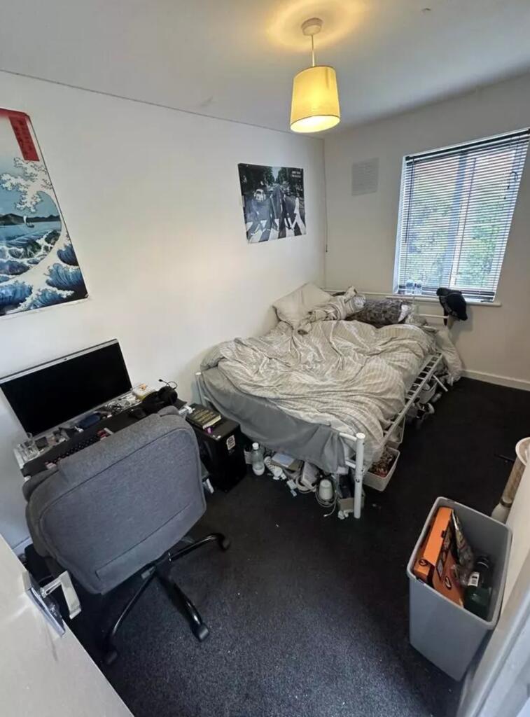 A cozy double bedroom with a comfortable bed an...