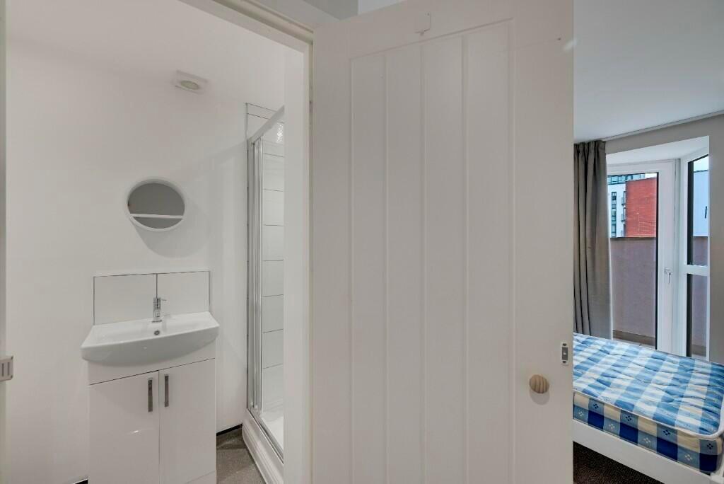 A clean and bright compact bathroom area featur...
