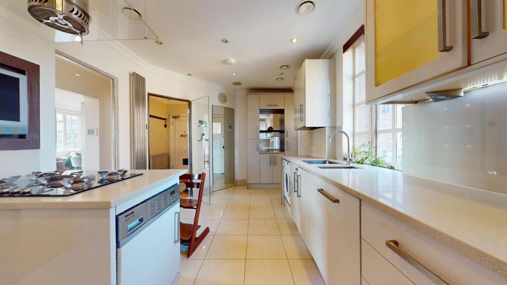 Bright and modern kitchen featuring sleek white...
