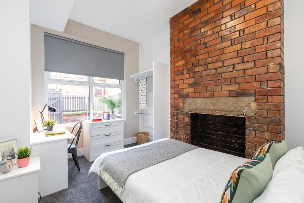 A bright and airy master bedroom featuring a co...