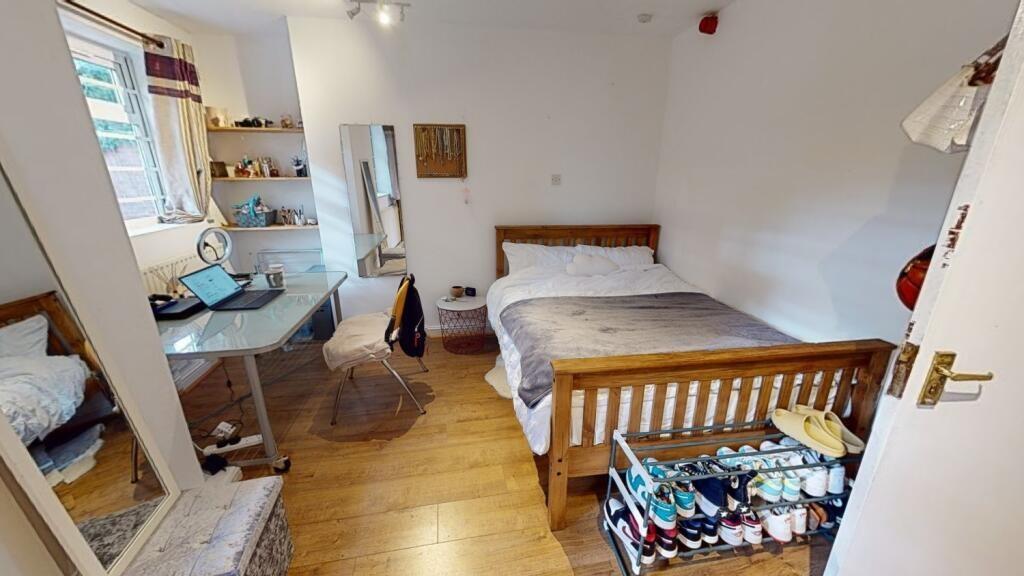A bright and well-kept double bedroom featuring...