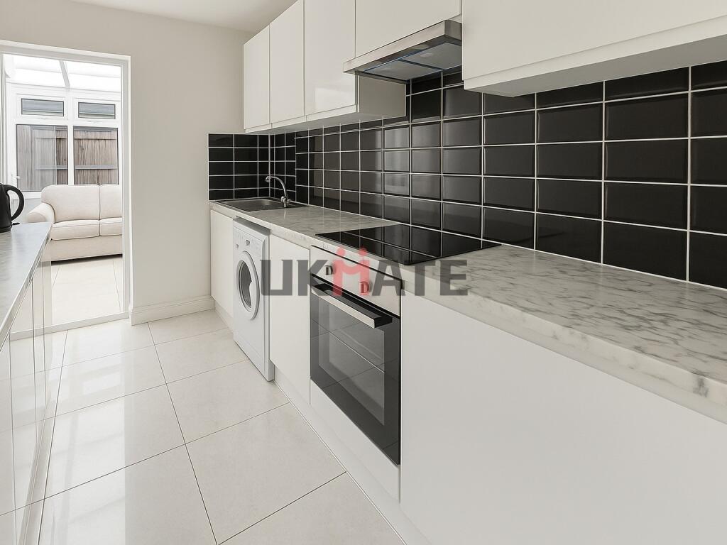 Modern, bright kitchen featuring sleek white ca...