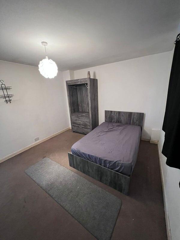 A tidy double bedroom featuring a comfortable b...