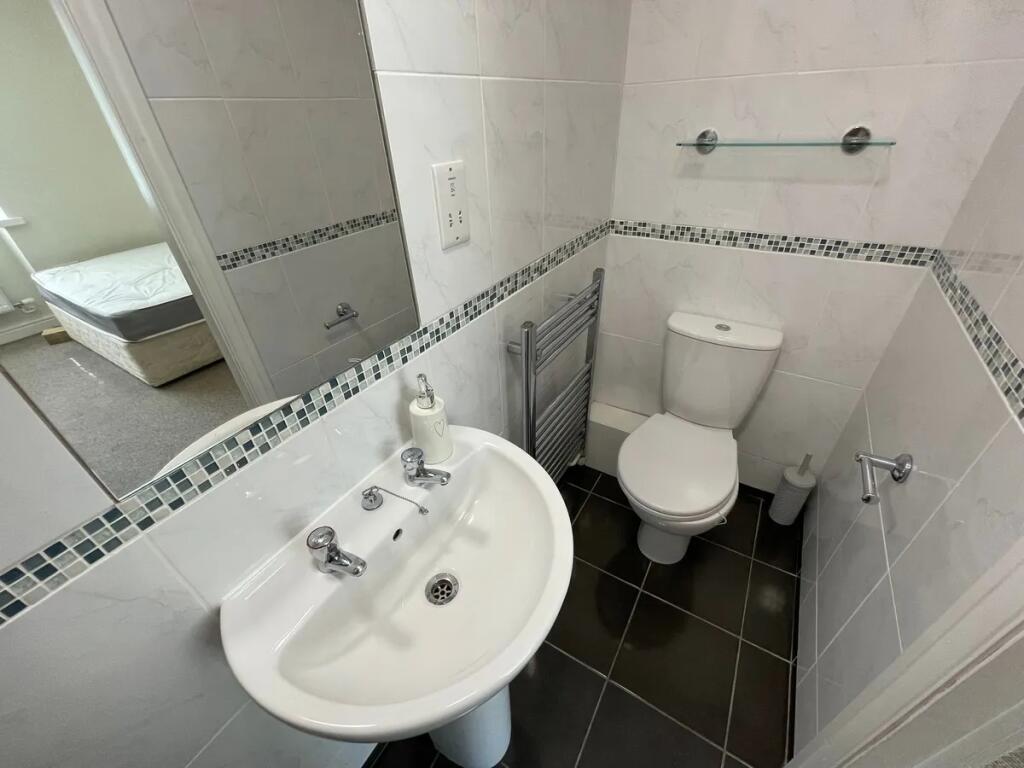 Bright and clean small toilet room featuring mo...