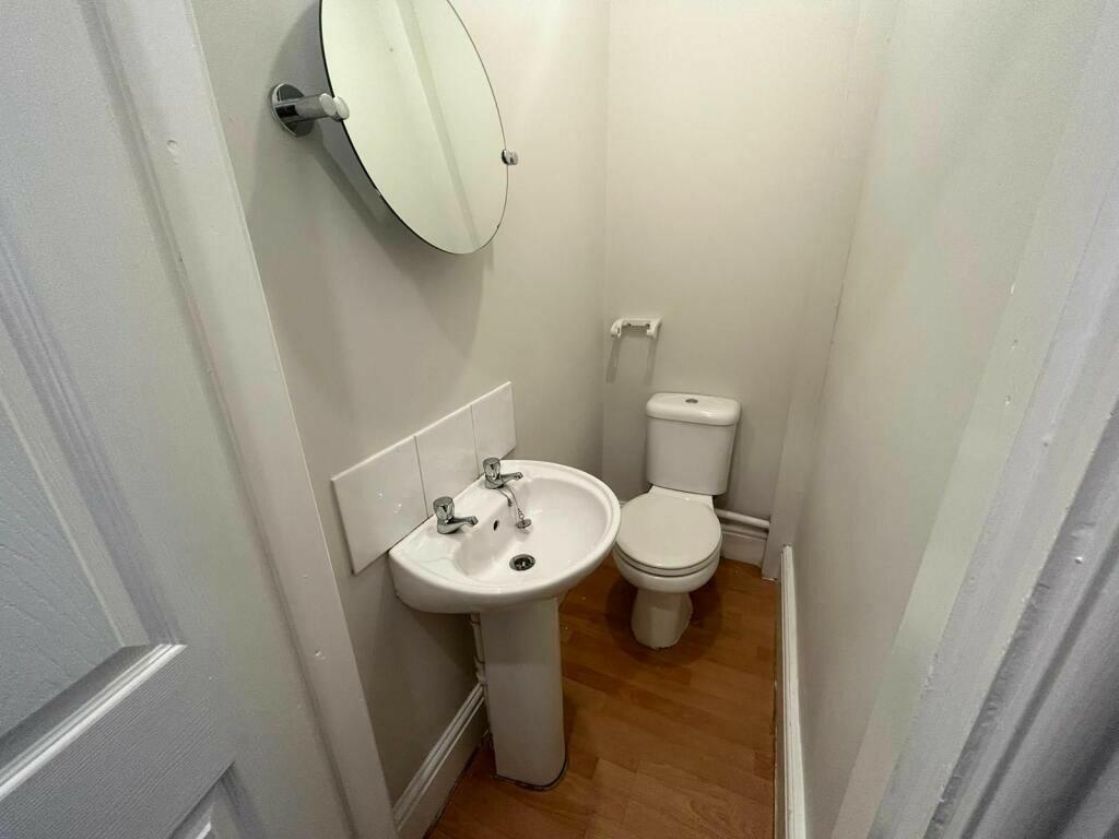 A clean and compact single toilet room featurin...