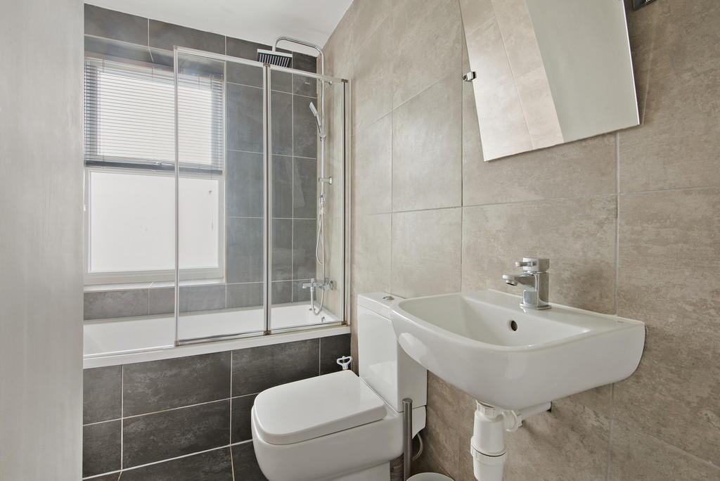 A modern bathroom suite featuring a bathtub wit...
