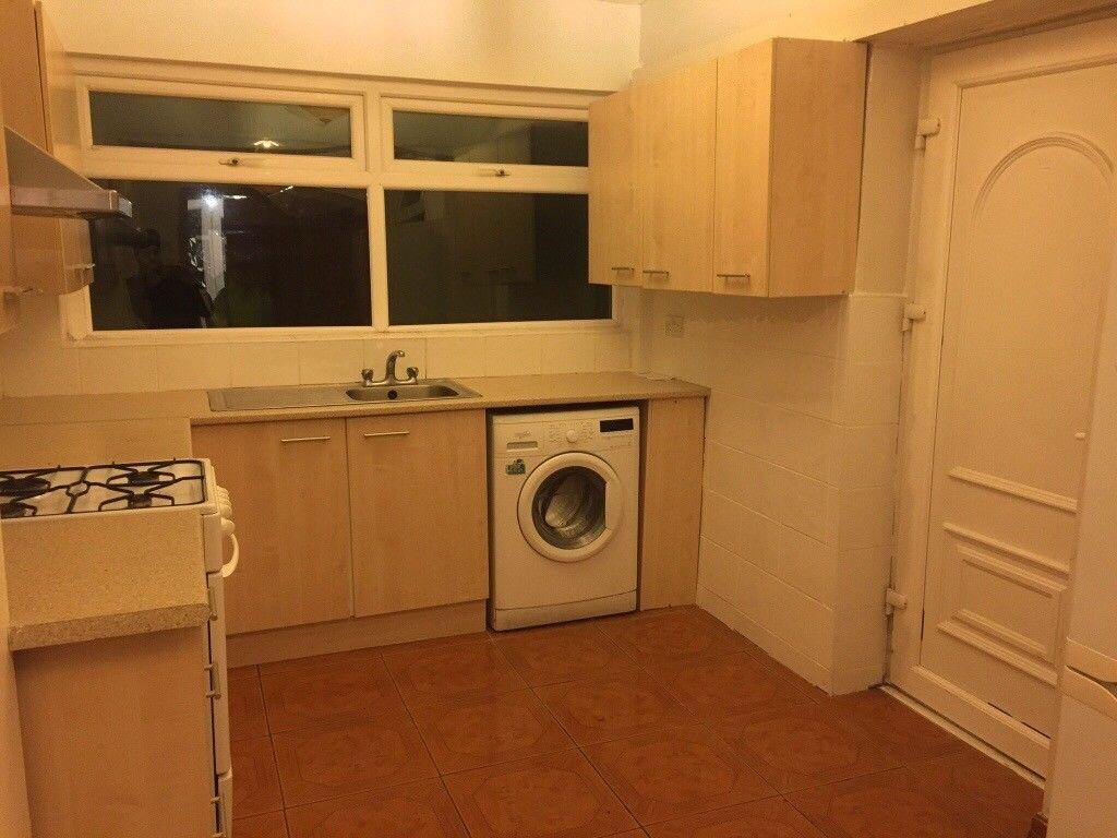 Well-equipped kitchen with light wood cabinets,...