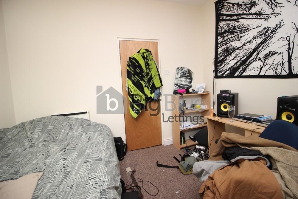 Cozy single bedroom featuring a comfortable bed...
