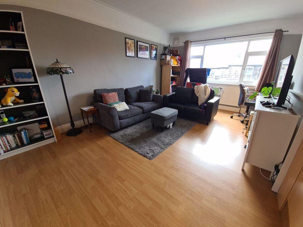 Bright, modern living room with large window, t...